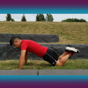 A man doing kneeling/modified push-ups on the grass.