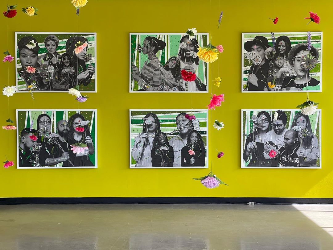 A series of portraits on a bright yellow wall.