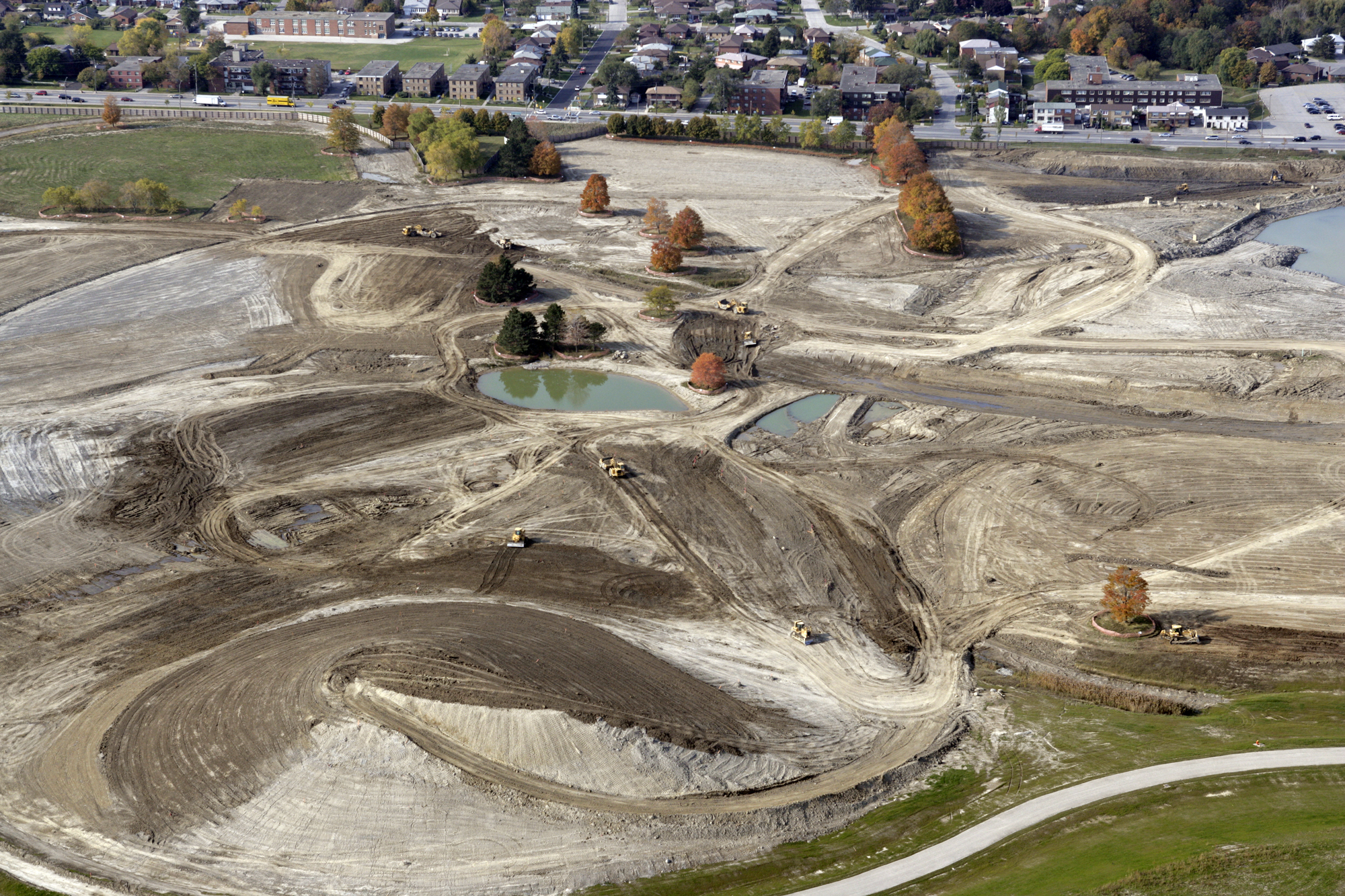 Bulldozers on dirt-covered paths and hills.