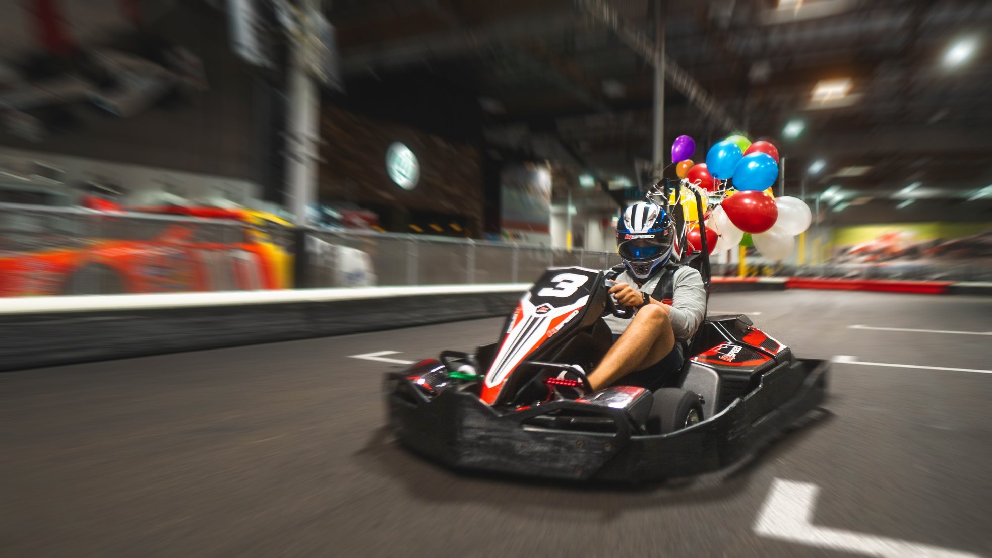 A close-up shot of a person racing a go-kart.