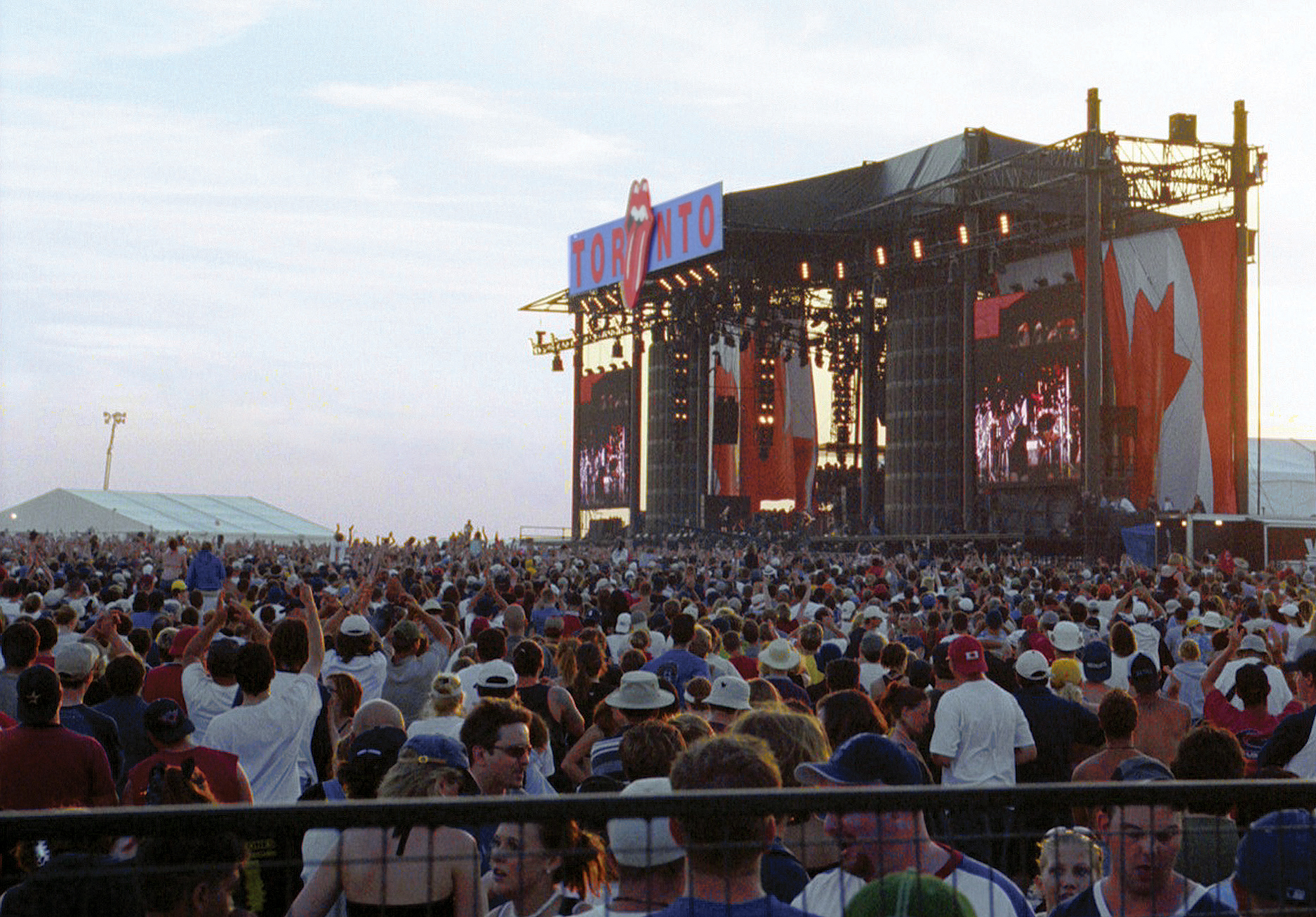 A large crowd of people in front of a massive stage.