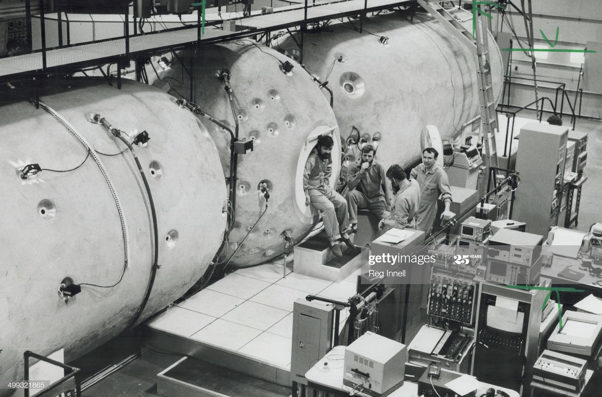 A black and white photo of a crew in front of machinery.