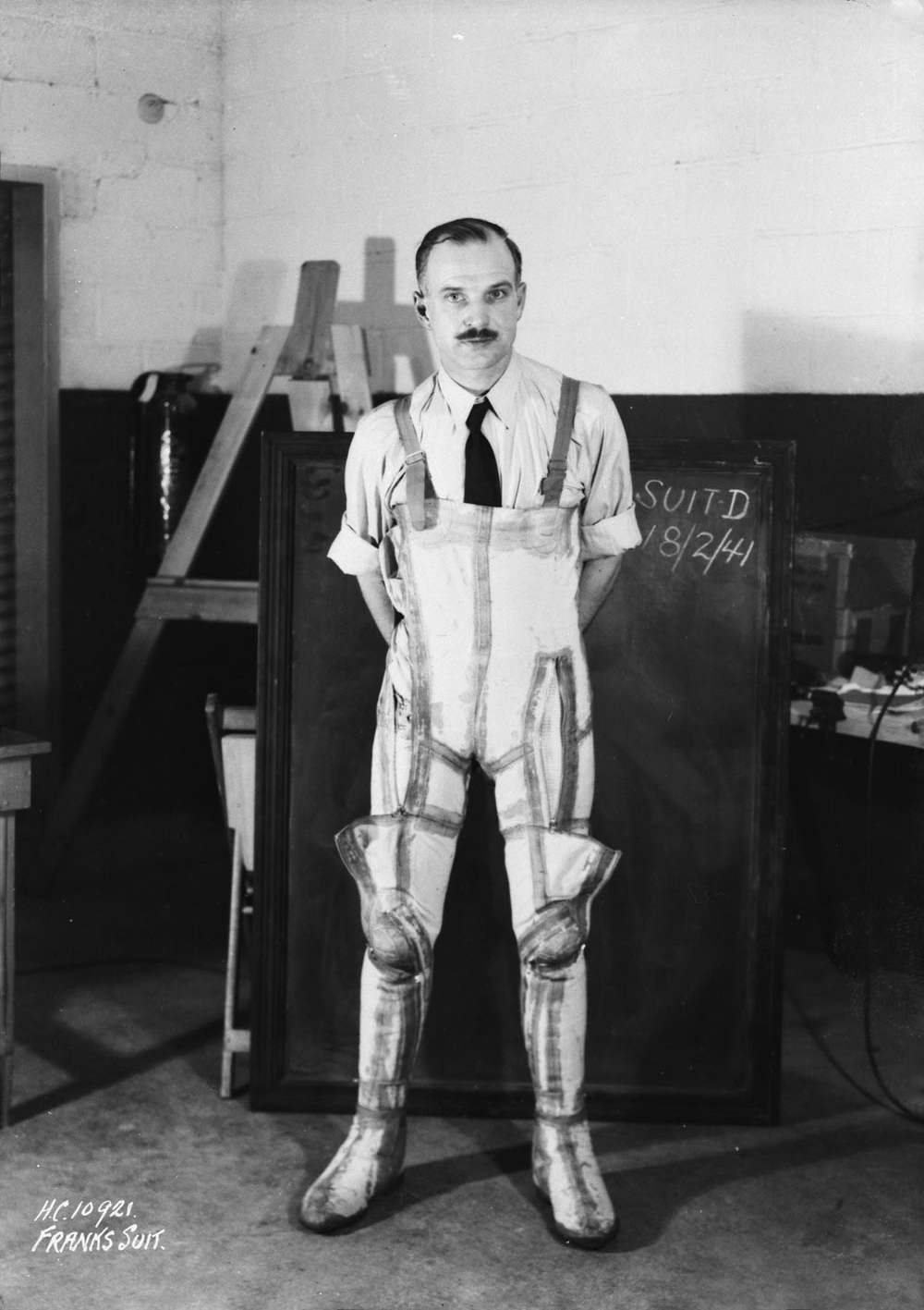 A black and white photo of a man in an anti-gravity suit.