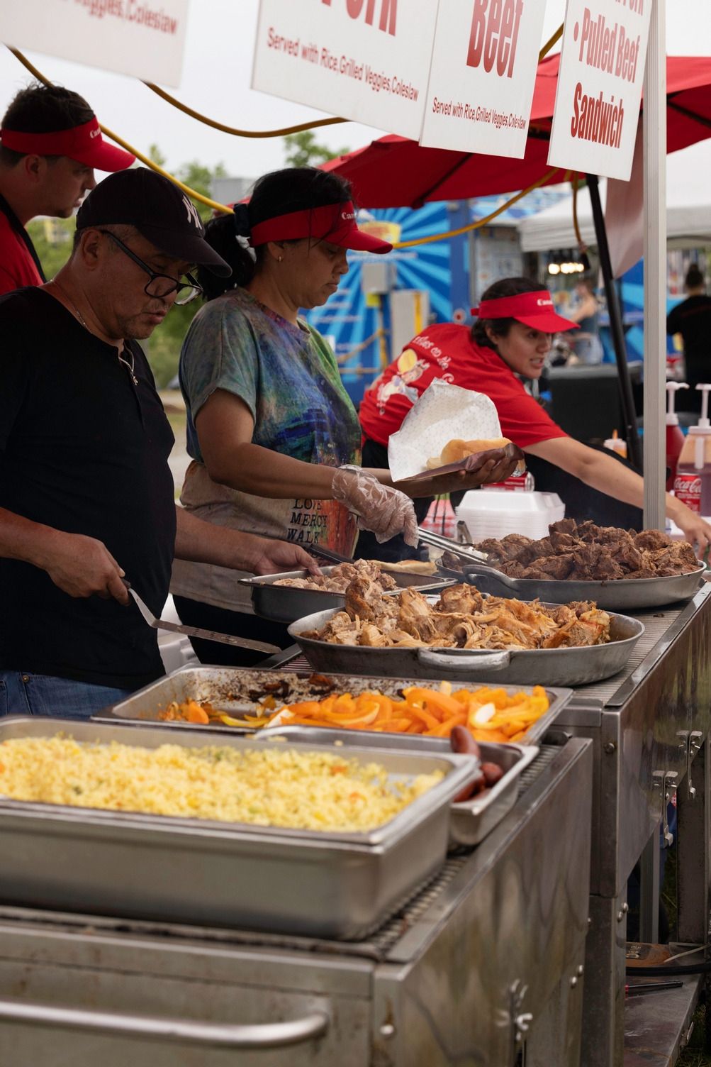 Food vendors cooking and selling food at their booth