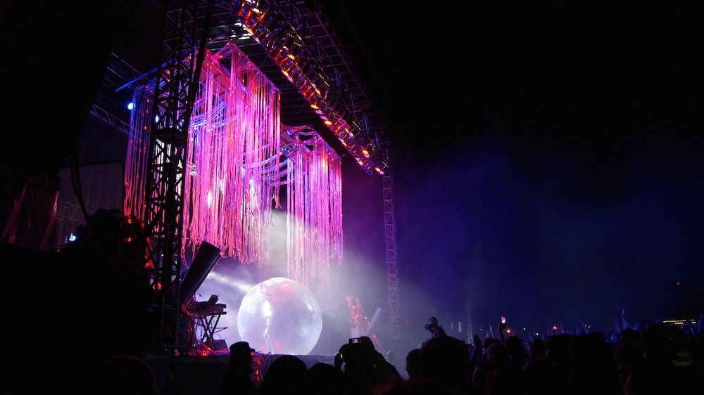 A large VELD stage featuring colourful spotlights and streamers.