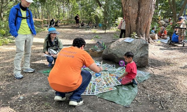 volunteer teaching a child and adults
