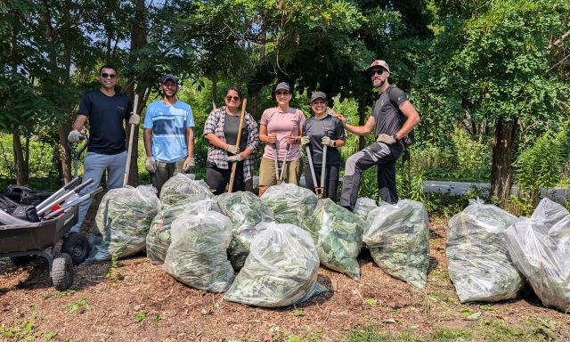 group in front of bags of weeds