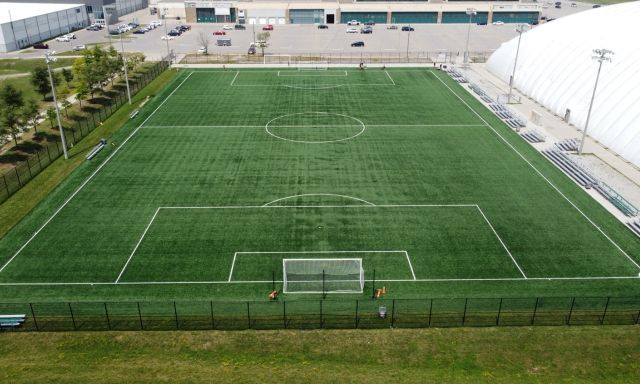 An aerial shot of a green soccer field.
