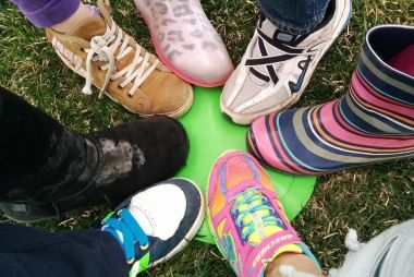 Kids stepping on a neon green flat pylon