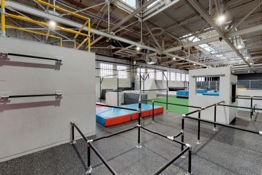 Bars, mats and more at an indoor parkour gym.