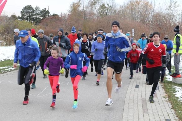 A group of people running at Downsview Park.