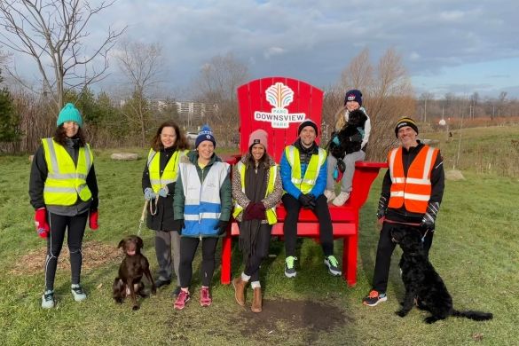 Downsview parkrun participants sitting on a giant Muskoka chair.