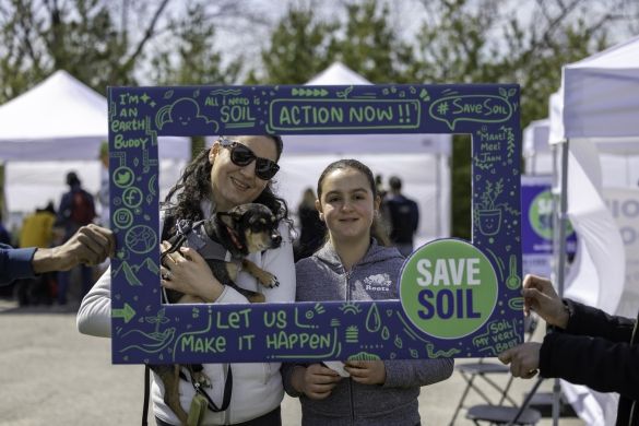 People taking photos at the Save Soil booth.