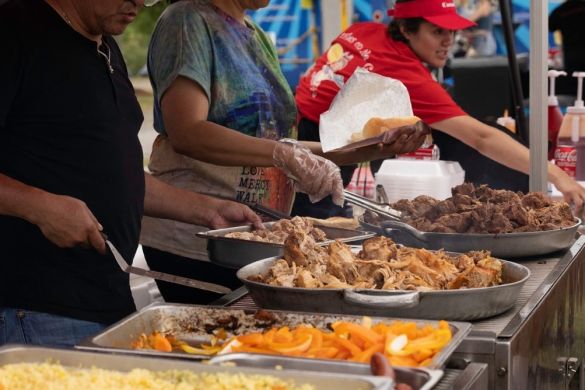 Food vendors cooking and selling food at their booth
