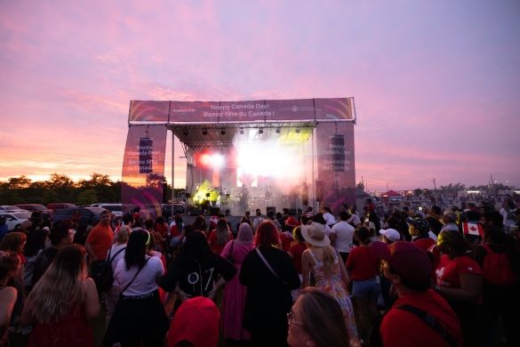 A crowd standing in front of the Canada Day stage