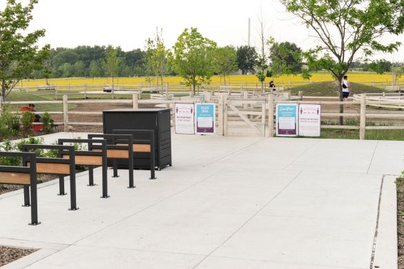 Bike racks and a double-gate entryway at the entrance of Dogsview Park.