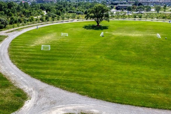 An aerial shot of a circular field with a path going around it.