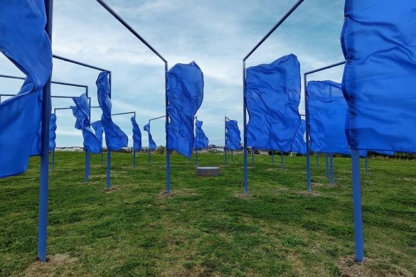 An art installation on top of the Mound featuring large blue flags.