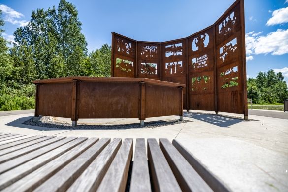 A corten steel art installation featuring images of significant historical events.