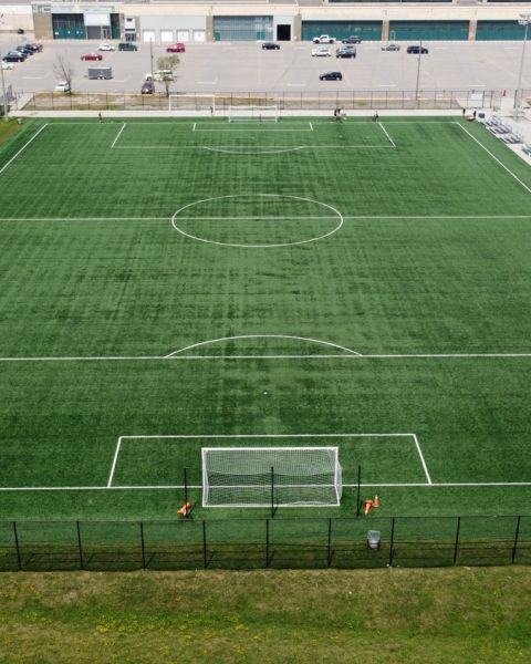 An aerial shot of a green soccer field. 