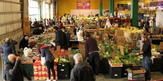 Fruits and veggies for sale in an indoor market.